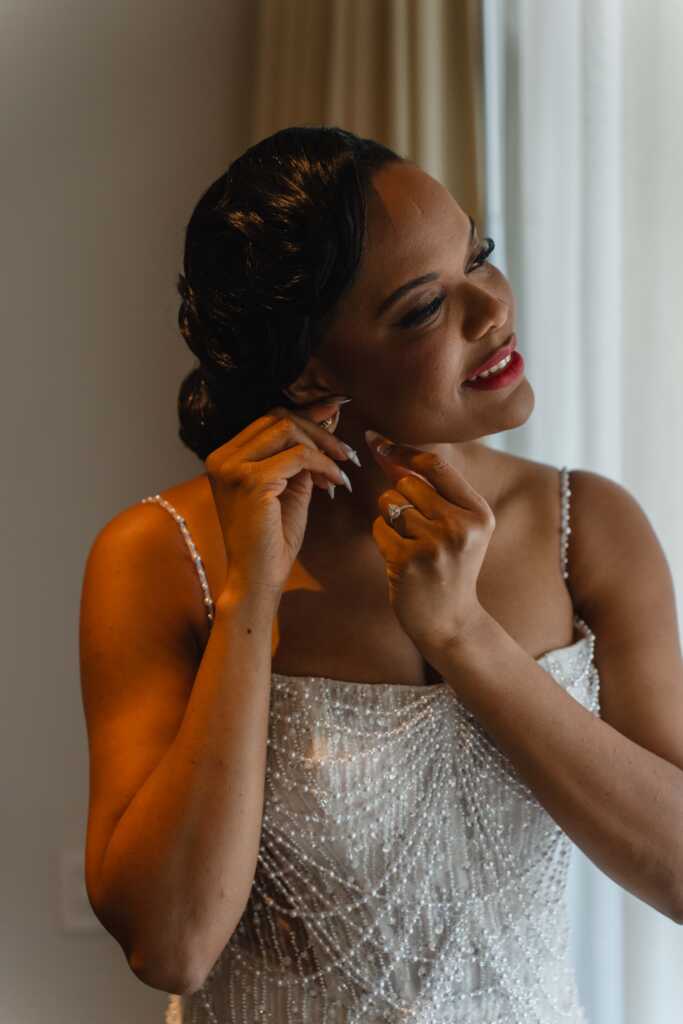 Bride putting on earrings Hacienda Encantada Los Cabos wedding