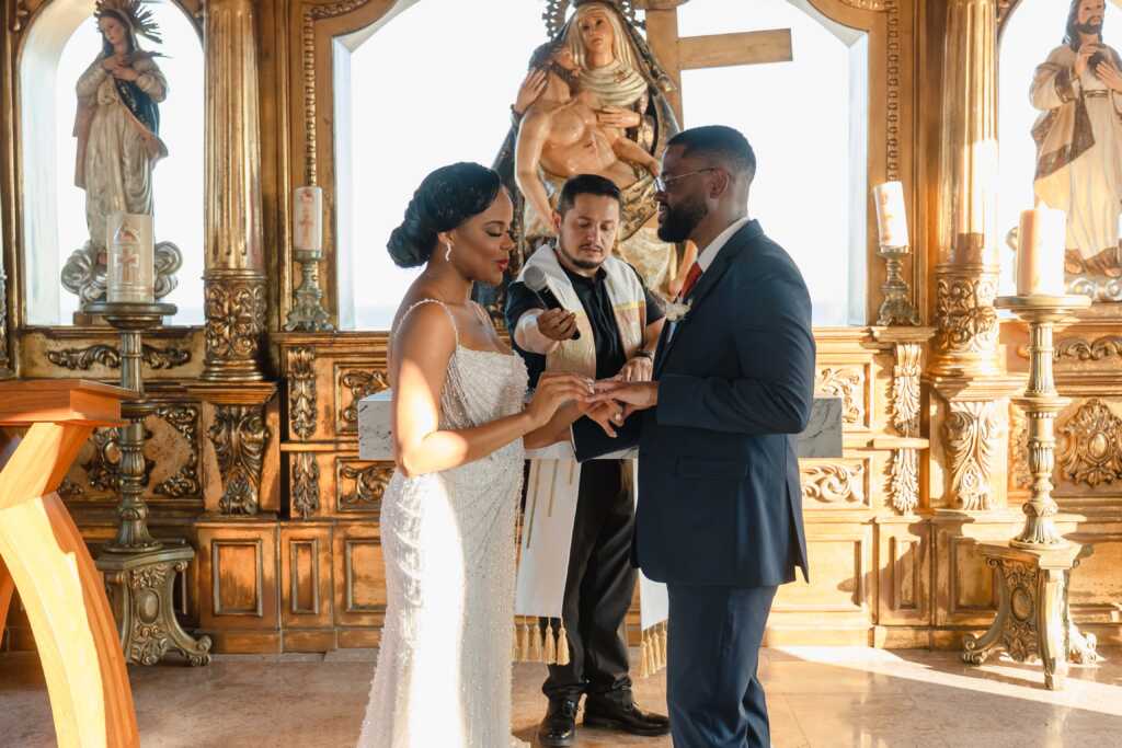 ride and groom exchanging rings Hacienda Encantada Cabo wedding ceremony