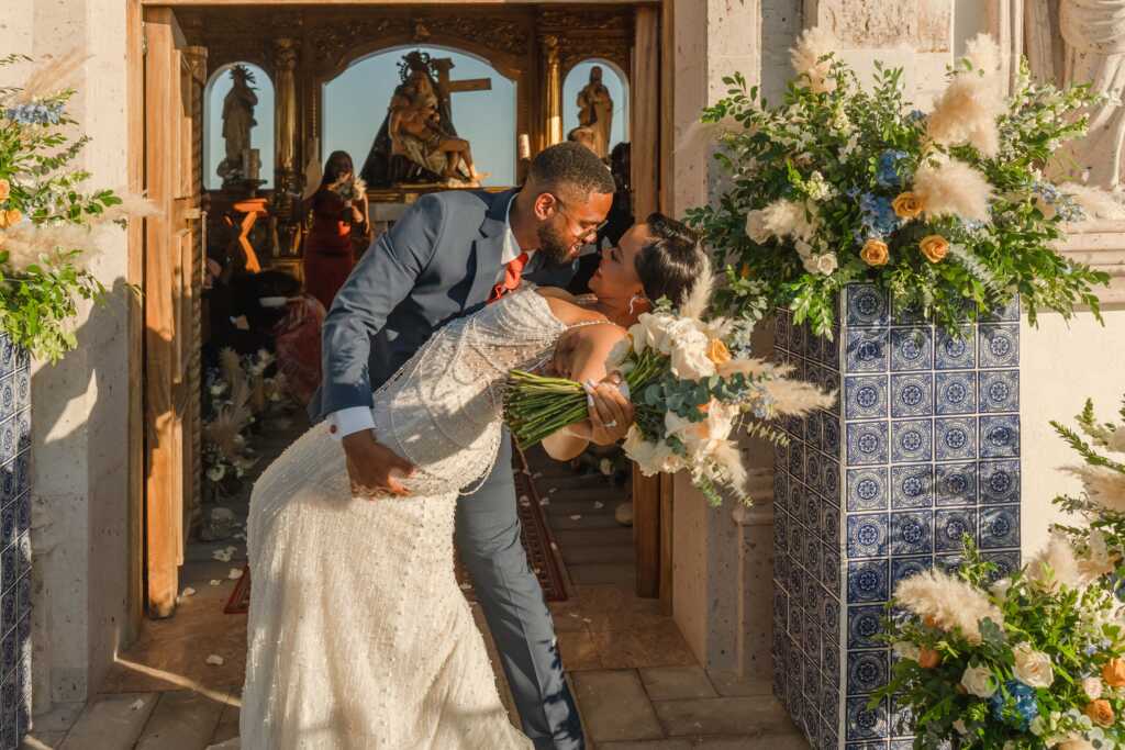 Bride and groom kissing outside chapel Hacienda Encantada Los Cabos wedding