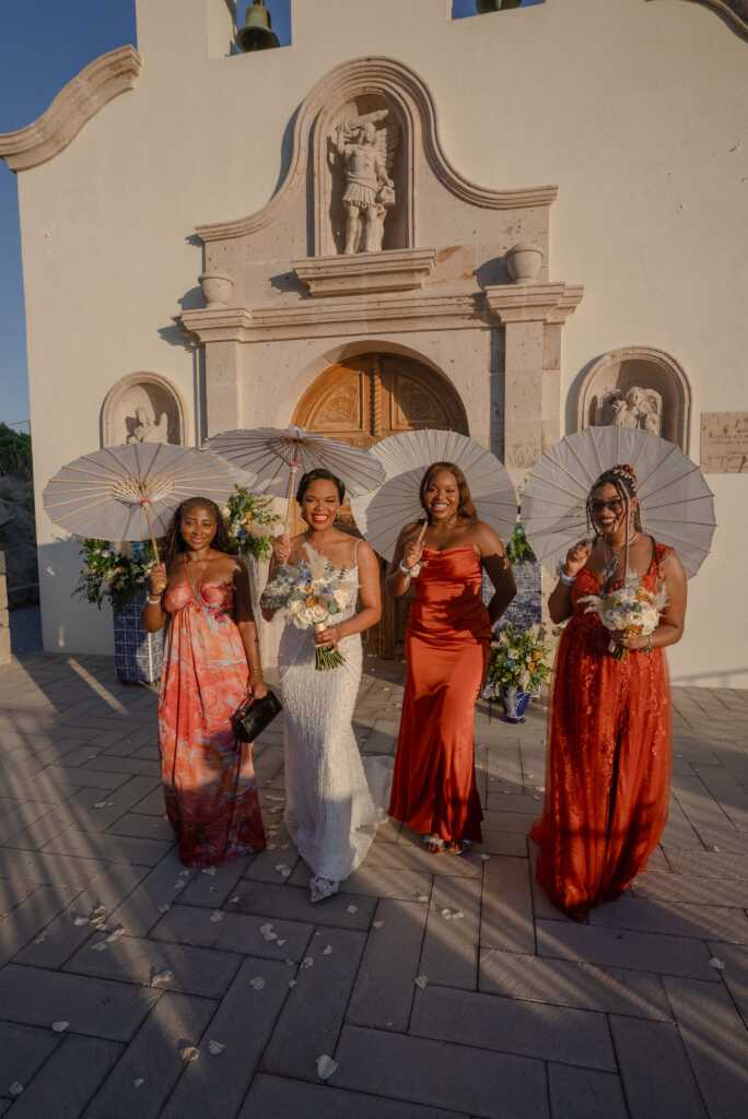 Bridesmaids with umbrellas outside chapel Hacienda Encantada Los Cabos wedding