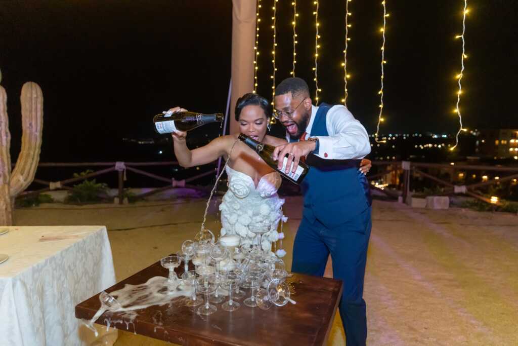 Bride and groom pouring champagne tower Hacienda Encantada Cabo Mexico