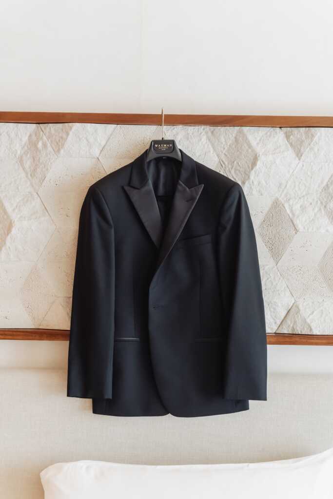 Groom’s wedding suit hanging at Nobu Hotel Los Cabos before an intimate destination wedding.