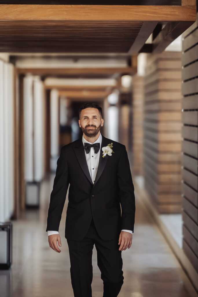 Groom walking through Nobu Hotel Los Cabos on his way to the wedding venue.