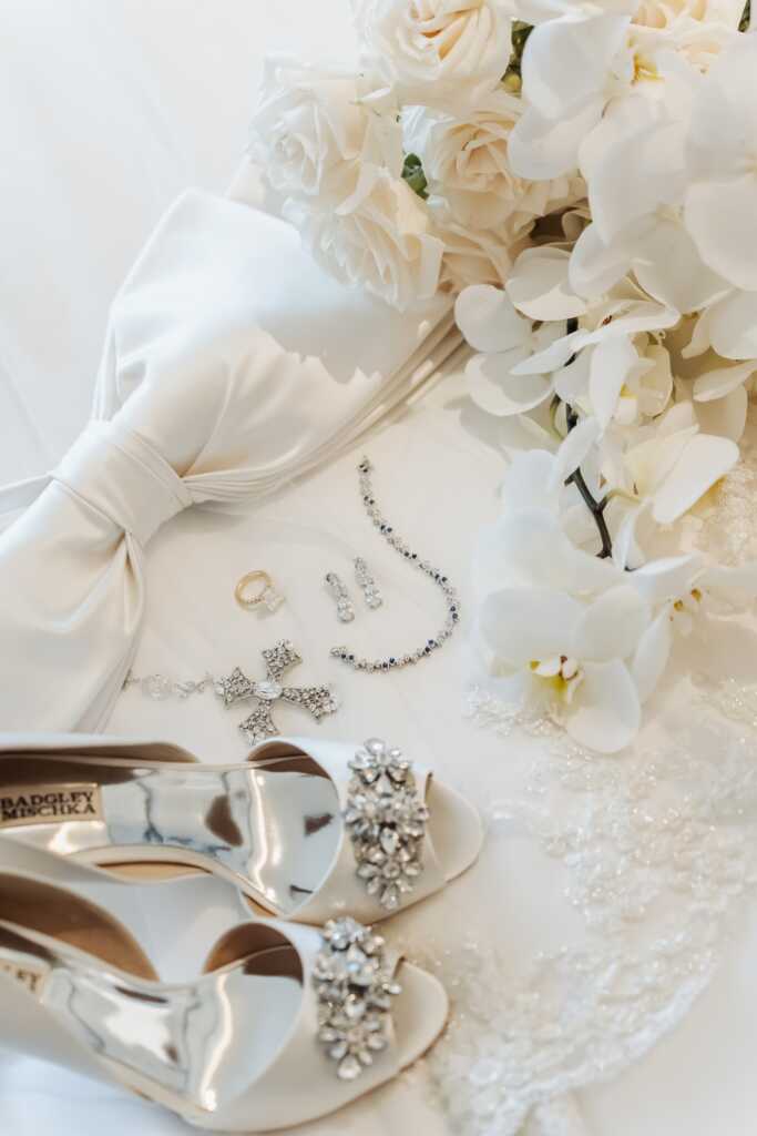 Bridal details including necklace, earrings, bouquet, and flowers at Nobu Hotel Los Cabos.