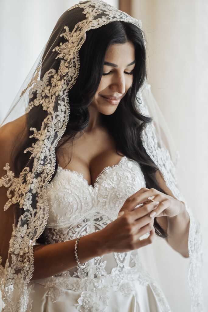 Bride looking at her wedding ring during the final getting-ready moments at Nobu Hotel Los Cabos.