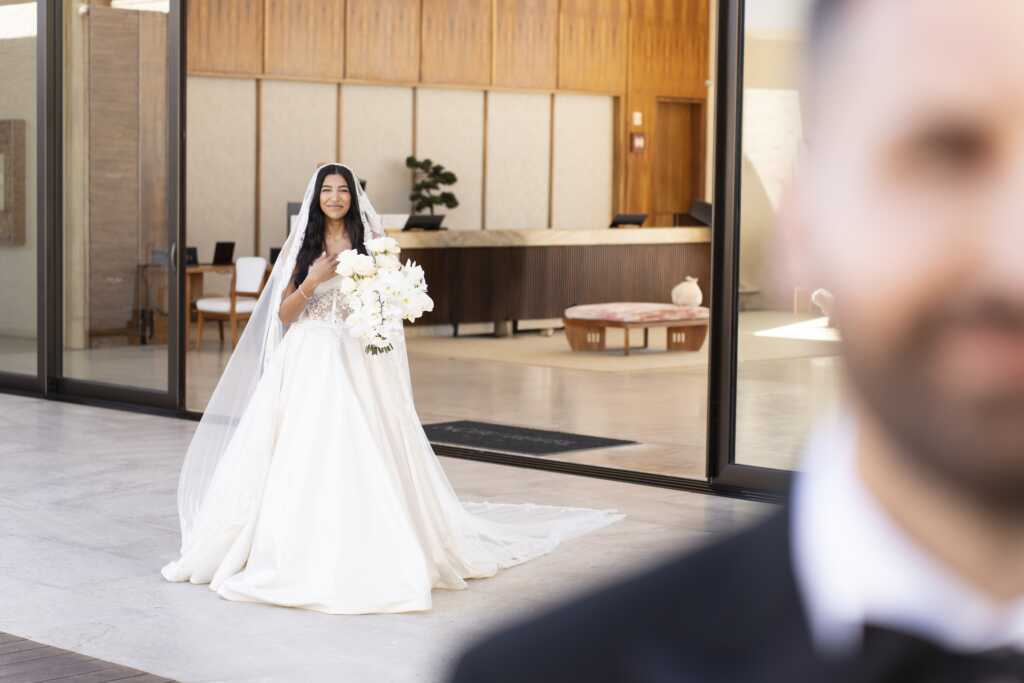 Bride walking to meet her groom for their first look at Nobu Hotel Los Cabos.